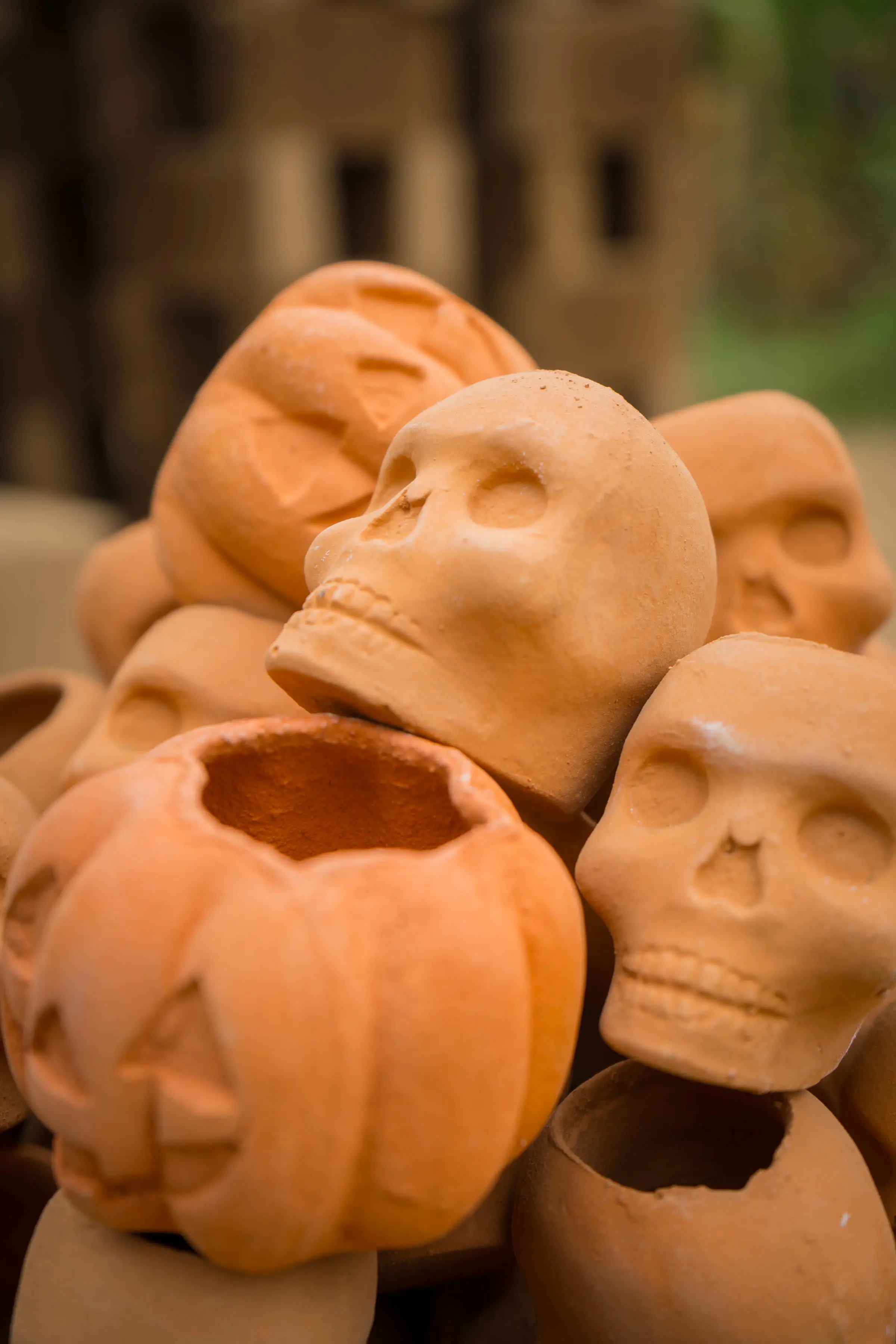 Calaveras y calabazas de barro cocido recien salidas del horno